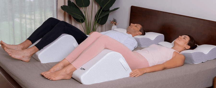ZenBloks Rest Ease ergonomic leg pillow wedge in ivory white displayed on bed for everyday comfort