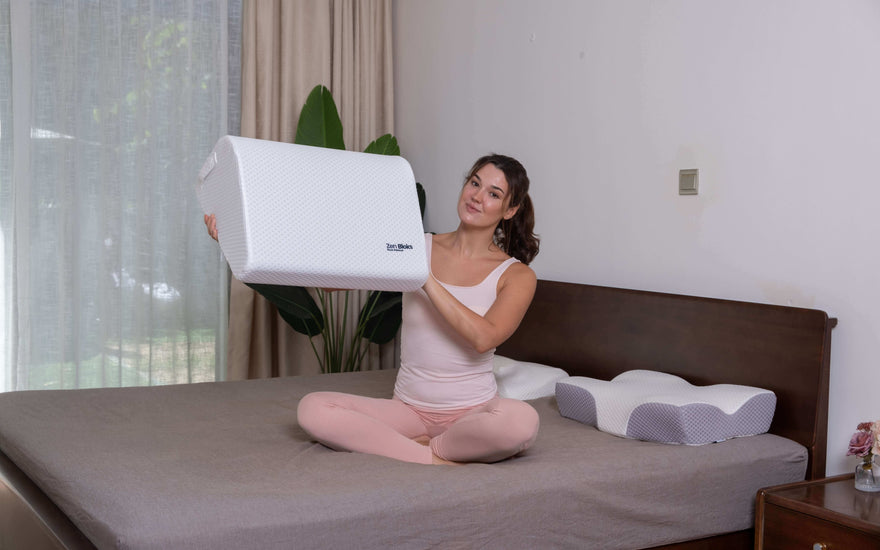 woman on bed holding up a leg elevation wedge pillow showing how light it is