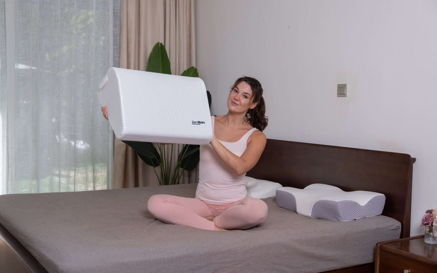 woman on bed holding up a leg elevation wedge pillow showing how light it is